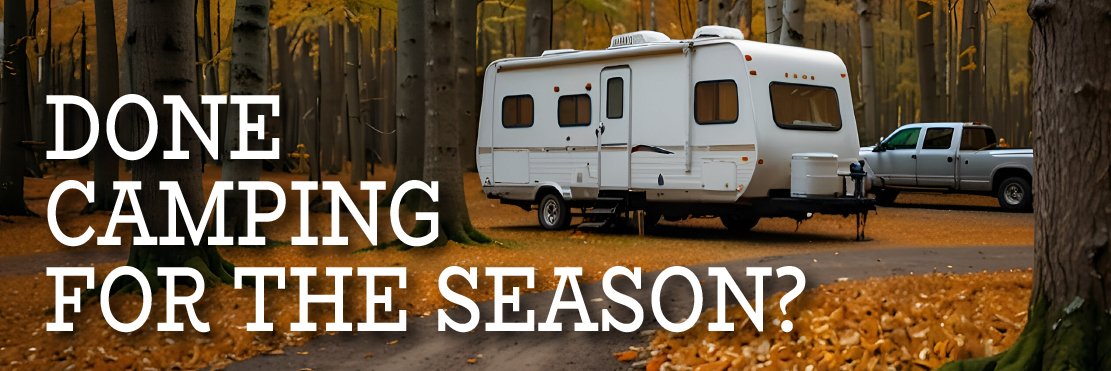 Travel trailer parked among fall leaves — done camping for the season?