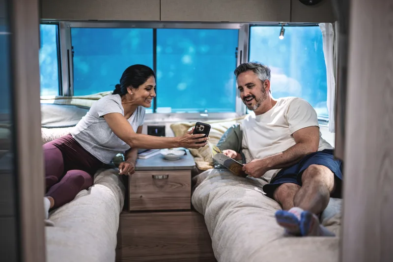 Couple relaxing in the lounge of an Airstream Flying Cloud