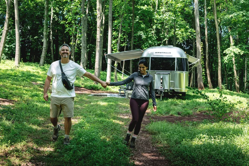 Couple walking from their Airstream Flying Cloud